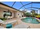 Enjoy this refreshing pool with waterfall feature and screened enclosure at 13376 Creekside Ln, Port Charlotte, FL 33953