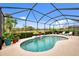 Relax and soak up the sun by this kidney-shaped pool and waterfall at 13376 Creekside Ln, Port Charlotte, FL 33953