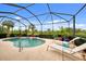 Relaxing kidney-shaped pool with waterfall feature and plenty of lounge space at 13376 Creekside Ln, Port Charlotte, FL 33953