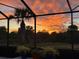 Stunning sunset view visible from the screened lanai at 13376 Creekside Ln, Port Charlotte, FL 33953