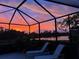 Tranquil sunset view over the water from the screened enclosure at 13376 Creekside Ln, Port Charlotte, FL 33953