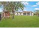 Large backyard featuring a house and a covered patio at 13478 Carrie Ave, Port Charlotte, FL 33953