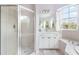 Bathroom with shower, bathtub, and white vanity at 13478 Carrie Ave, Port Charlotte, FL 33953