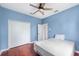 Blue bedroom with a king bed and double doors at 13478 Carrie Ave, Port Charlotte, FL 33953