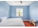 Blue bedroom with a king bed and wood floors at 13478 Carrie Ave, Port Charlotte, FL 33953