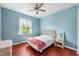 Light blue bedroom with a queen bed and wood floors at 13478 Carrie Ave, Port Charlotte, FL 33953