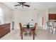 Dining room with dark wood table and kitchen view at 13478 Carrie Ave, Port Charlotte, FL 33953