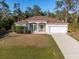 Single story home with brown roof and white walls, two car garage at 13478 Carrie Ave, Port Charlotte, FL 33953