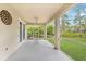 Screened porch overlooks a grassy backyard at 13478 Carrie Ave, Port Charlotte, FL 33953