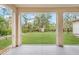 Screened porch with view of fenced backyard at 13478 Carrie Ave, Port Charlotte, FL 33953