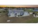 Aerial view of house with canal and neighborhood views at sunset at 142 Broadmoor Ln, Rotonda West, FL 33947