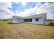 House exterior showcasing a large backyard and screened patio at 142 Broadmoor Ln, Rotonda West, FL 33947