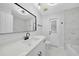 Modern bathroom with white vanity, black matte fixtures, and marble tile at 142 Broadmoor Ln, Rotonda West, FL 33947