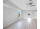 Spacious bedroom with light grey walls, wood-look flooring, and ceiling fan at 142 Broadmoor Ln, Rotonda West, FL 33947