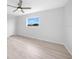 Simple bedroom with hardwood floors and a window at 142 Broadmoor Ln, Rotonda West, FL 33947