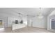 Modern kitchen with white cabinets and island at 142 Broadmoor Ln, Rotonda West, FL 33947