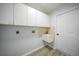 Laundry room with white cabinets and vinyl flooring at 142 Broadmoor Ln, Rotonda West, FL 33947