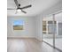 Bright living room with vaulted ceiling, hardwood floors, and sliding glass doors at 142 Broadmoor Ln, Rotonda West, FL 33947