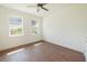 Bedroom with two windows, wood-look floors, and ceiling fan at 159 Colony Point Dr, Punta Gorda, FL 33950