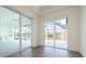 Bright dining room with sliding glass doors leading to a pool and lake view at 159 Colony Point Dr, Punta Gorda, FL 33950