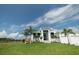 White house with two-car garage, overlooking a canal at 159 Colony Point Dr, Punta Gorda, FL 33950