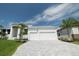 White two-story house with a three-car garage and palm trees at 159 Colony Point Dr, Punta Gorda, FL 33950