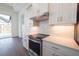 Modern kitchen with white cabinets, a herringbone backsplash, and stainless steel appliances at 159 Colony Point Dr, Punta Gorda, FL 33950