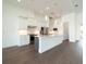 Modern kitchen with white cabinets, large island, and wood flooring at 159 Colony Point Dr, Punta Gorda, FL 33950