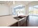 Modern kitchen with a farmhouse sink and island overlooking a pool at 159 Colony Point Dr, Punta Gorda, FL 33950