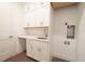 Bright laundry room with white cabinets and countertop at 159 Colony Point Dr, Punta Gorda, FL 33950