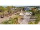 Aerial view of a residential lot with surrounding houses and trees at 1665 Manor Rd, Englewood, FL 34223