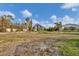 View of an empty lot with surrounding houses and trees at 1665 Manor Rd, Englewood, FL 34223