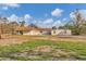 Single-story house exterior with damaged pool enclosure at 1665 Manor Rd, Englewood, FL 34223