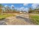 Single-story house exterior with damaged pool enclosure at 1665 Manor Rd, Englewood, FL 34223