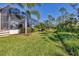 Landscaped backyard with screened patio and lush tropical foliage at 17 Par View Pl, Rotonda West, FL 33947