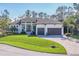 Stunning exterior of a two-story home with a three-car garage and manicured lawn at 17 Par View Pl, Rotonda West, FL 33947