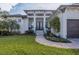 Elegant house entrance with double doors and landscaping at 17 Par View Pl, Rotonda West, FL 33947