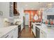 Sleek kitchen with white cabinets, marble countertops, and a stylish backsplash at 17 Par View Pl, Rotonda West, FL 33947