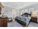 Relaxing main bedroom with a large bed, dark wood furniture, and a ceiling fan at 17 Par View Pl, Rotonda West, FL 33947