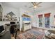 Bright home office features built-in shelving, a large TV, and French doors leading to the outdoors at 17 Par View Pl, Rotonda West, FL 33947