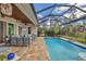 Spacious pool and patio area with covered lanai, comfortable seating, and lush landscaping at 17 Par View Pl, Rotonda West, FL 33947