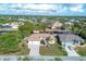 An aerial view of a canal front home with a paved driveway at 17164 Canary Ln, Port Charlotte, FL 33948