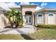 Front view of house with a brick walkway and palm trees at 17164 Canary Ln, Port Charlotte, FL 33948