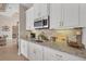 Kitchenette with granite countertop and white cabinetry at 17164 Canary Ln, Port Charlotte, FL 33948