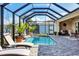 Large screened pool and patio with lounge chairs at 17164 Canary Ln, Port Charlotte, FL 33948