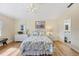 Main bedroom with white wicker furniture and floral bedding at 185 Cougar Way, Rotonda West, FL 33947