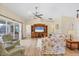 Bright living room with floral sofas, wood flooring, and views of the pool at 185 Cougar Way, Rotonda West, FL 33947