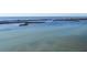 Wide view of calm water, a shoreline and distant city at 1900 Illinois Ave, Englewood, FL 34224