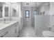 Updated bathroom with double vanity, shower and linen closet at 1954 Arkansas Ave, Englewood, FL 34224