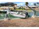 Private boat lift with small motor boat in a canal at 1954 Arkansas Ave, Englewood, FL 34224